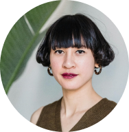 Woman with blunt bangs and hoop earrings