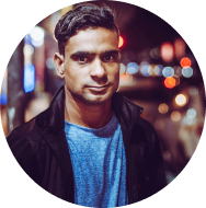 A man with city lights behind him