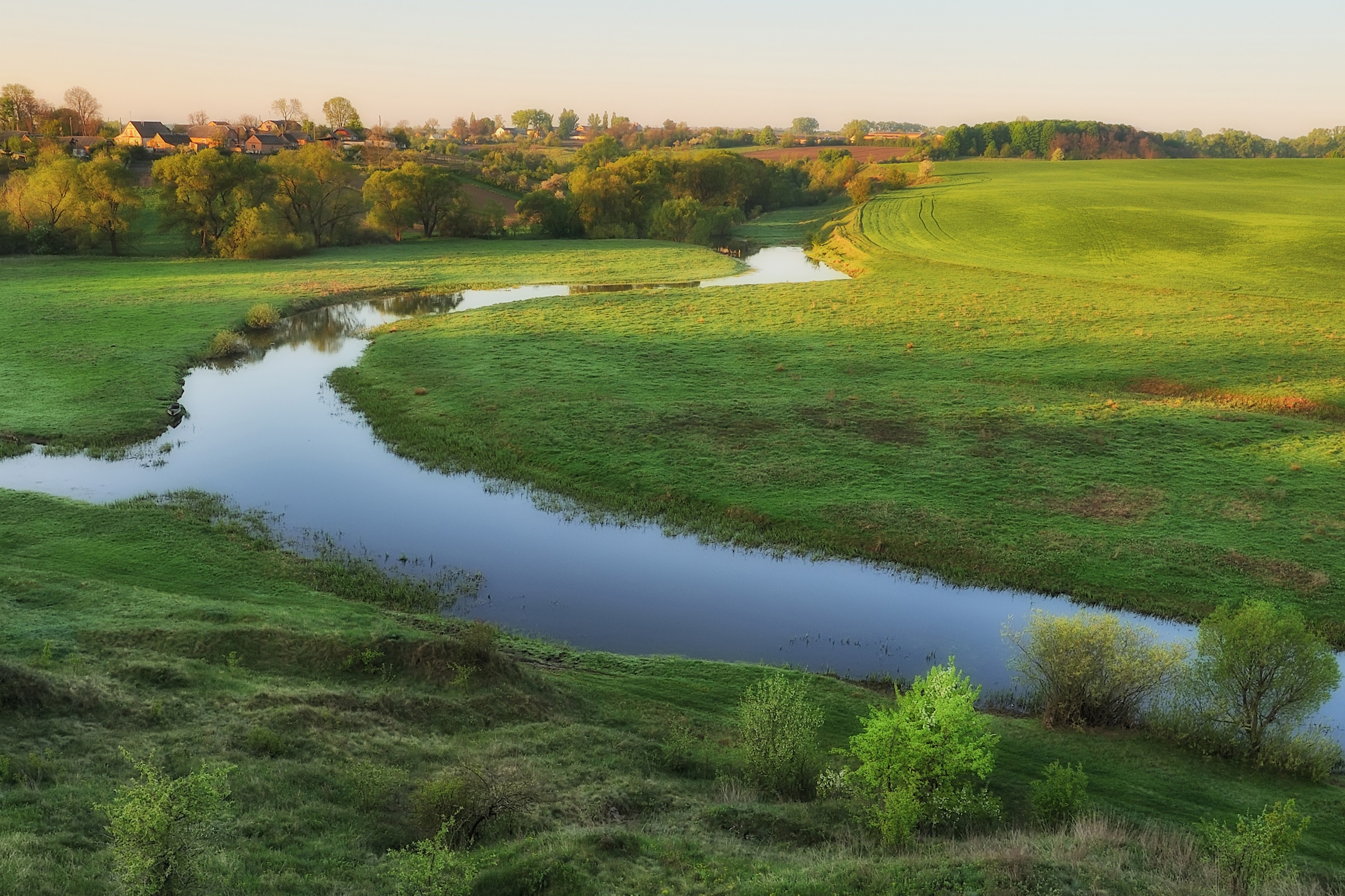 Grassy field with stream in the Summer