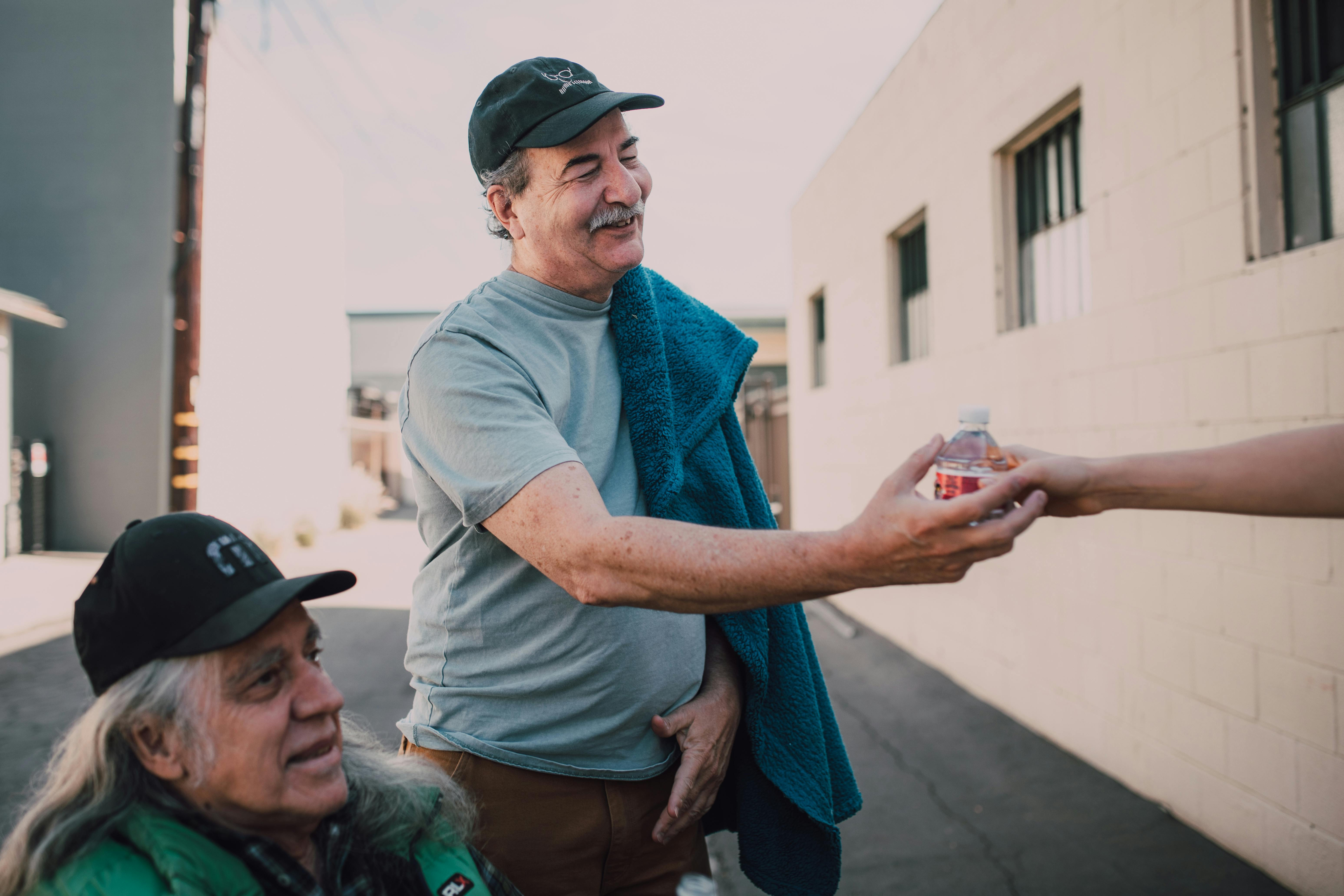 Person handing food to another person.