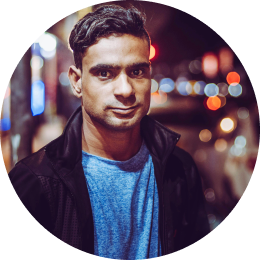 A man with city lights behind him